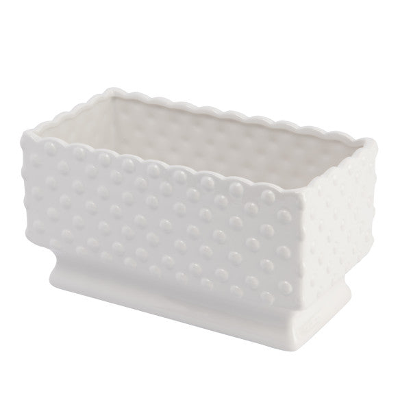 A white ceramic planter with a hobnail texture, scalloped edge, and polka dots.